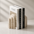 Natural marble stone bookends with stepped arch design holding art books