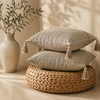 Japanese Linen Tassel Cushion Cover in Natural Linen — two cushions stacked on rattan pouf