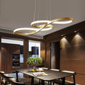 Gold music note LED pendant chandelier hanging above a dark wood dining table in a modern luxury dining room