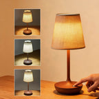 Wireless LED fabric table lamp in brown finish on a wooden desk showing three brightness levels and touch control base
