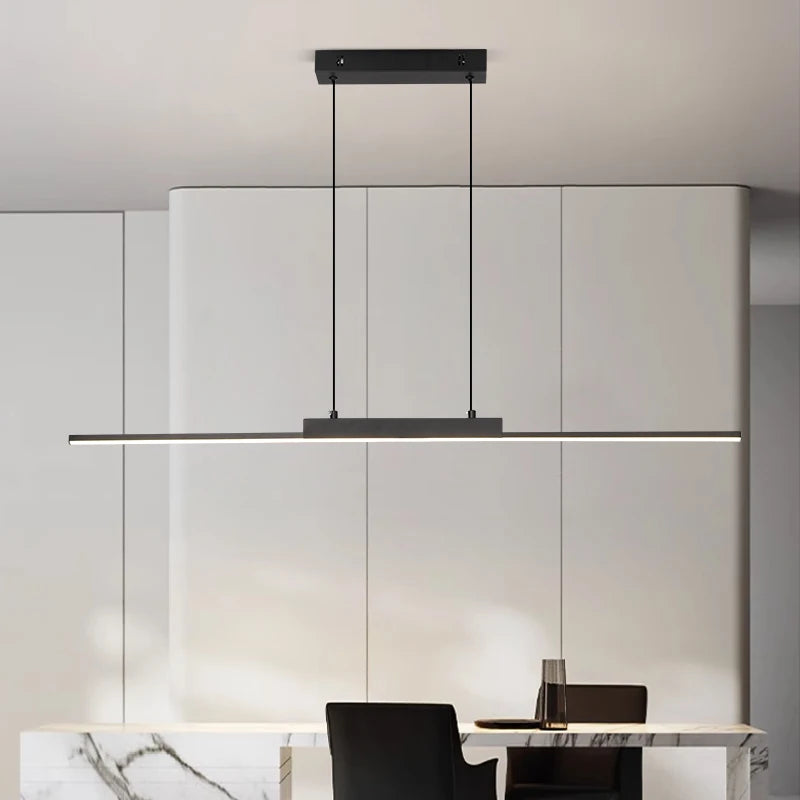 Linear LED pendant light over a white dining table