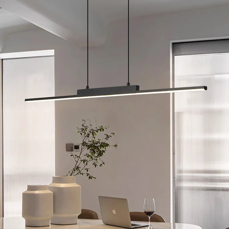 Linear LED pendant light in a minimalist living and dining space