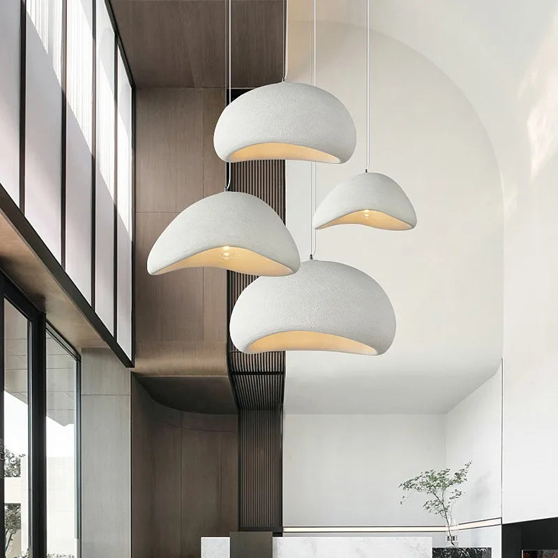 Multiple Wabi Sabi pendant lights in white hanging in a modern open-plan space