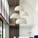 Multiple Wabi Sabi pendant lights in white hanging in a modern open-plan space