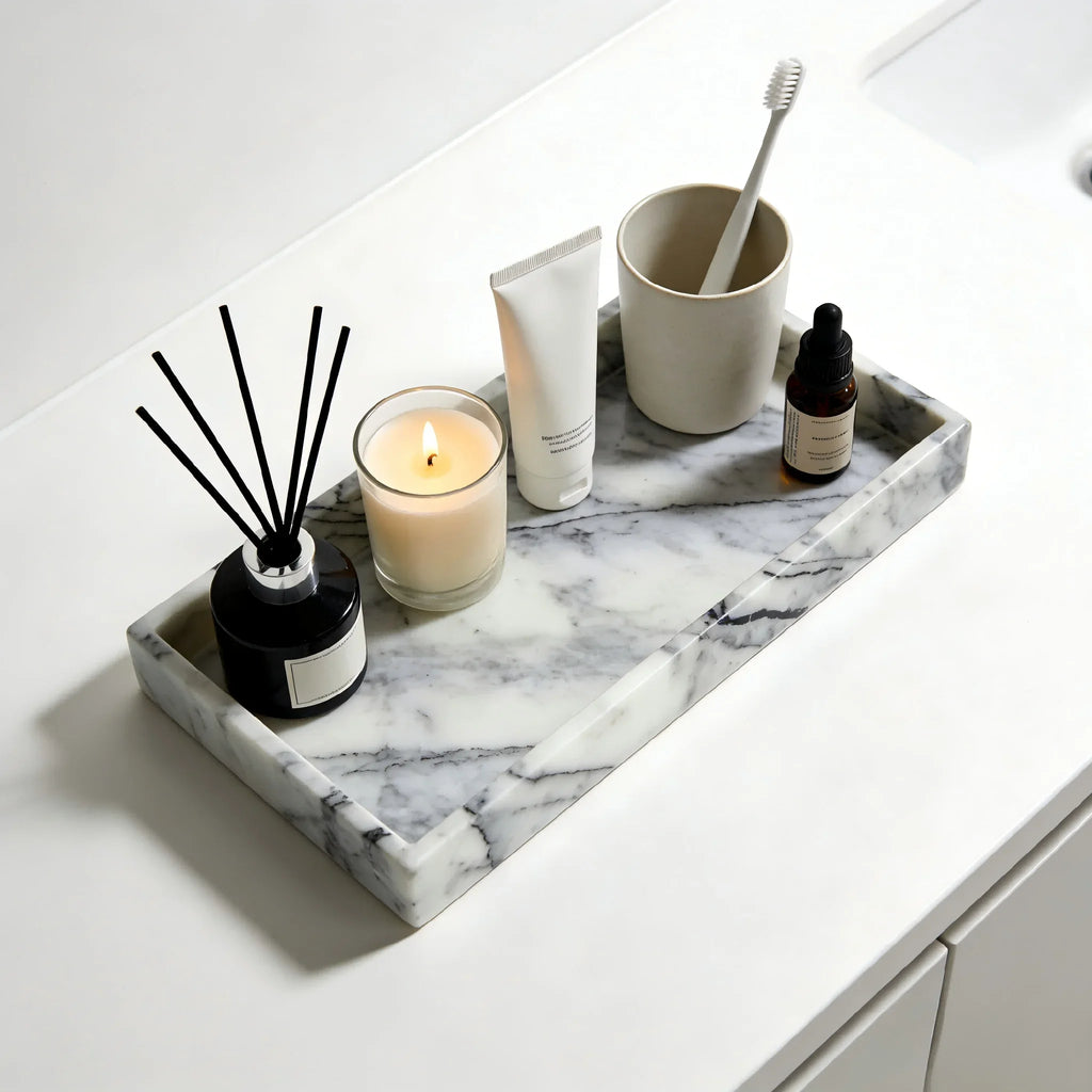 Marble tray styled on bathroom counter with candle, diffuser, and skincare products
