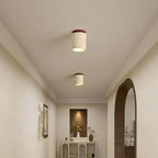 Travertine stone and wood flush mount ceiling lights installed in a minimalist Japanese-style hallway corridor