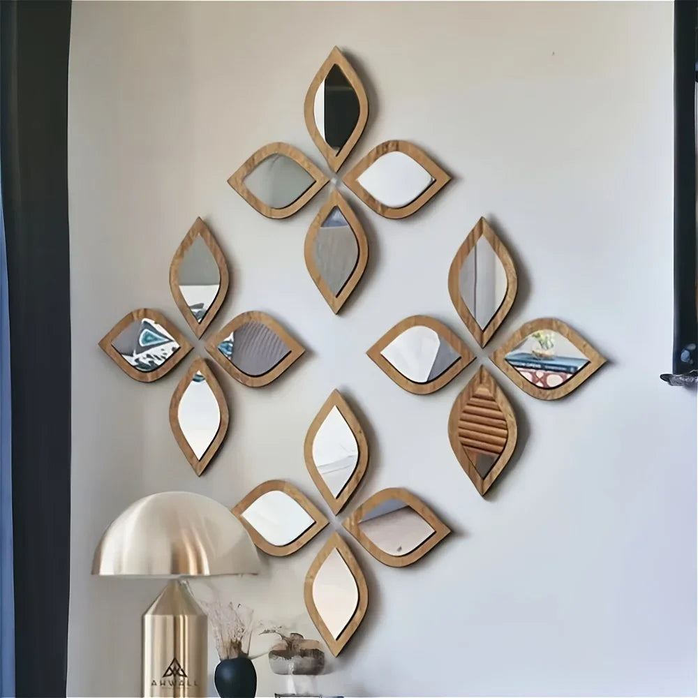 Multiple leaf-shaped wood frame mirrors arranged in a floral diamond pattern on a living room wall