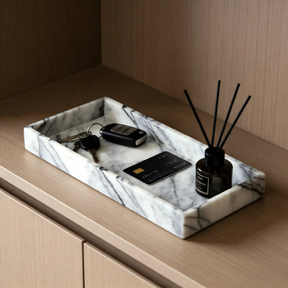 Marble tray on dresser with keys, card, and reed diffuser
