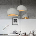 Wabi Sabi hand-knitted pendant lights in grey hanging in a minimalist living room