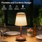Wireless LED fabric table lamp in gold finish on a dinner table showing portable cordless design with touch control icons