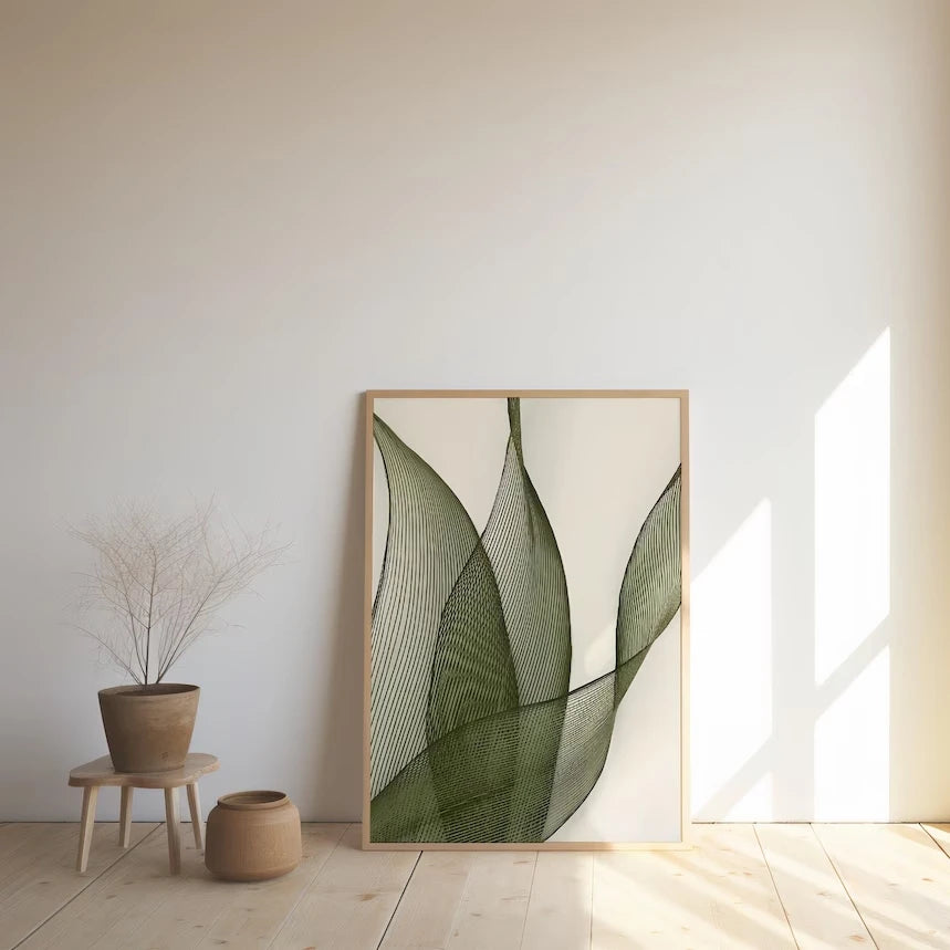 Large minimalist green leaf line art print leaning against a white wall in a minimalist Japandi space
