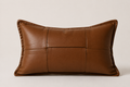 Woven leather lumbar pillow cover in cognac brown on white background – 30x50cm