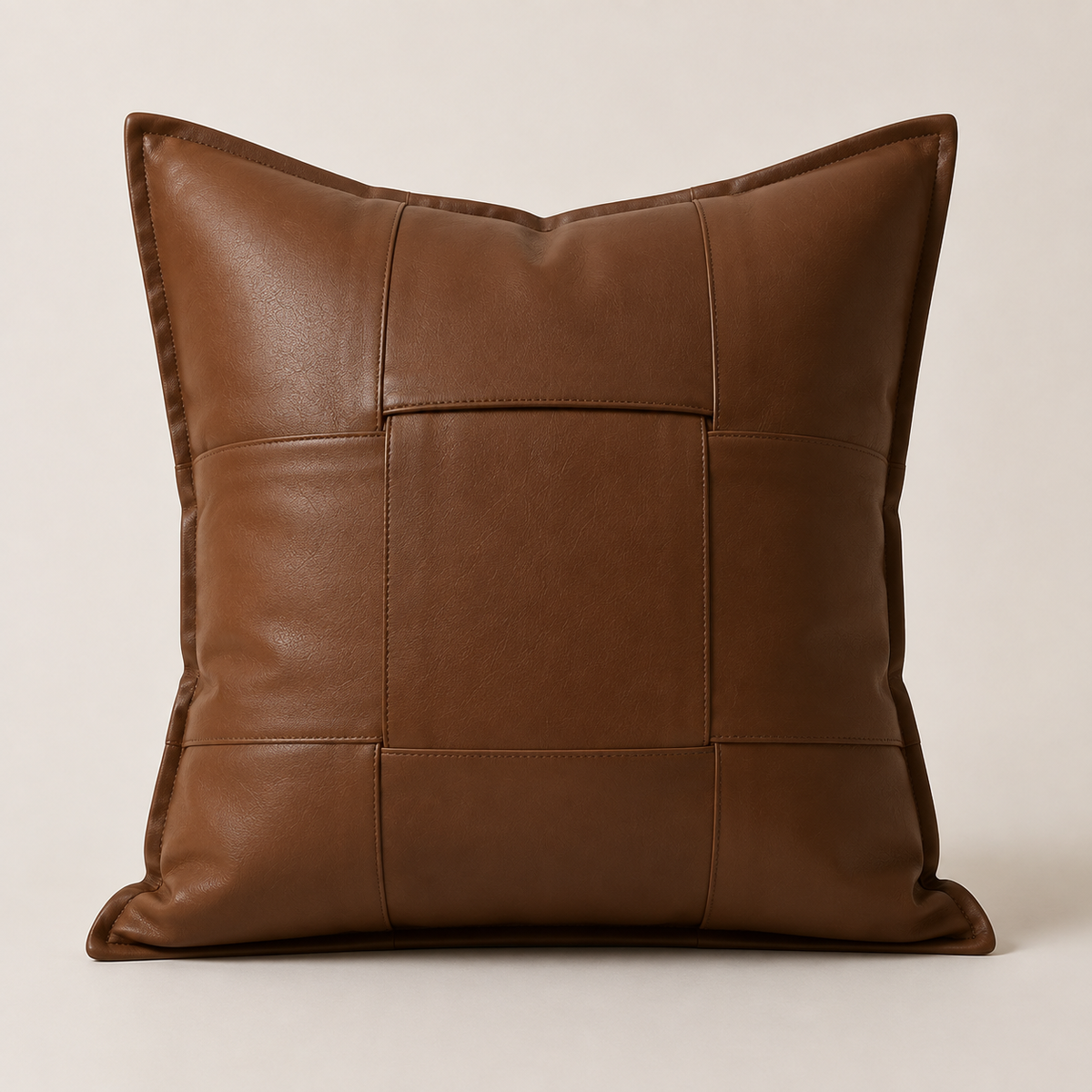 Woven leather throw pillow cover in cognac brown on white background